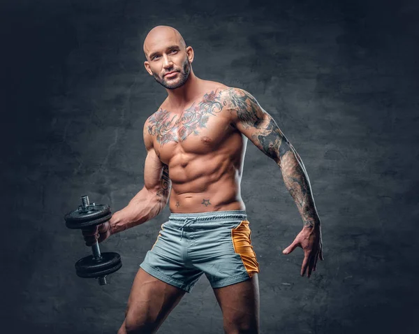 Tetovált férfi tartja súlyzó — Stock Fotó
