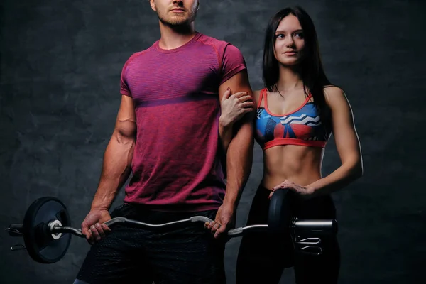 Man and woman with barbell — Stock Photo, Image