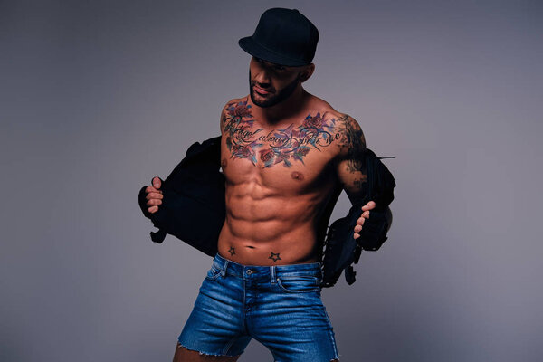 Татуированный мужчина, одетый в джинсы
