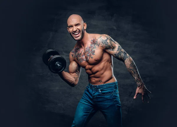 Shirtless man holds the dumbbell — Stock Photo, Image