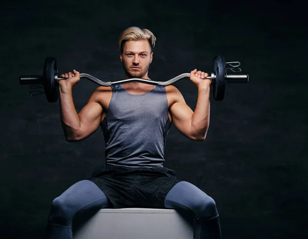 Sporty male holds barbell — Stock Photo, Image