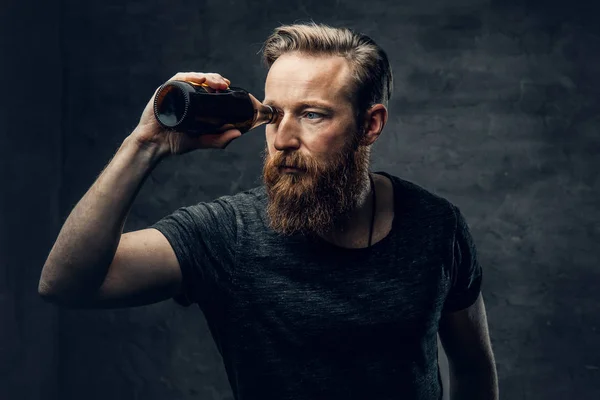 Male looking through beer bottle — Stock Photo, Image