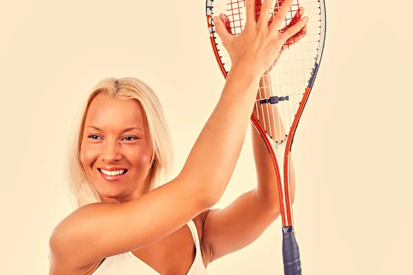 Sporty female holds a tennis racket — Stock Photo, Image