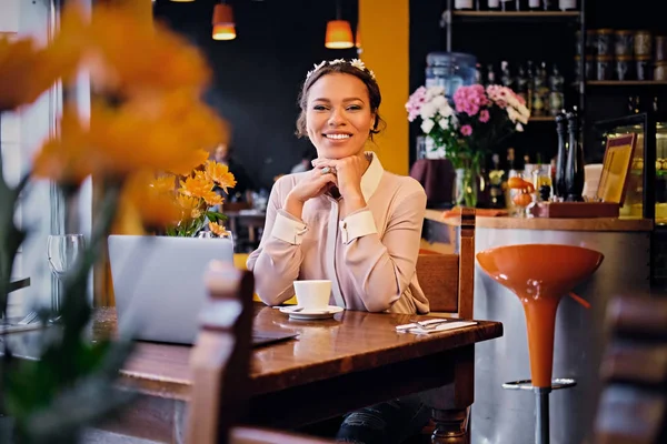 Black American woman in a cafe.