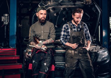 Two bearded tattooed mechanics clipart