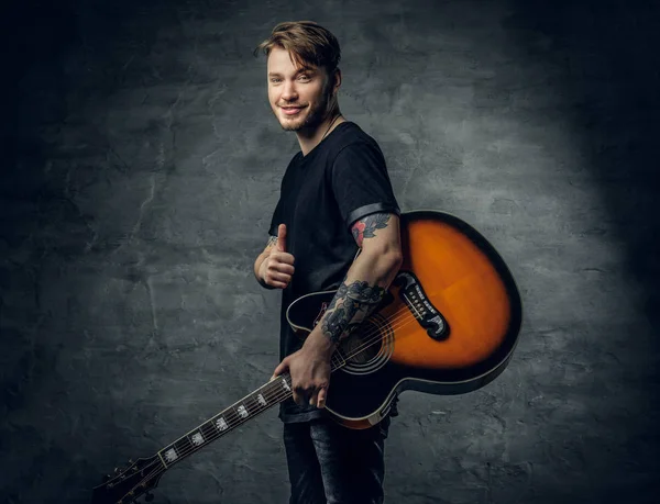 Stylish hipster holds guitar — Stock Photo, Image