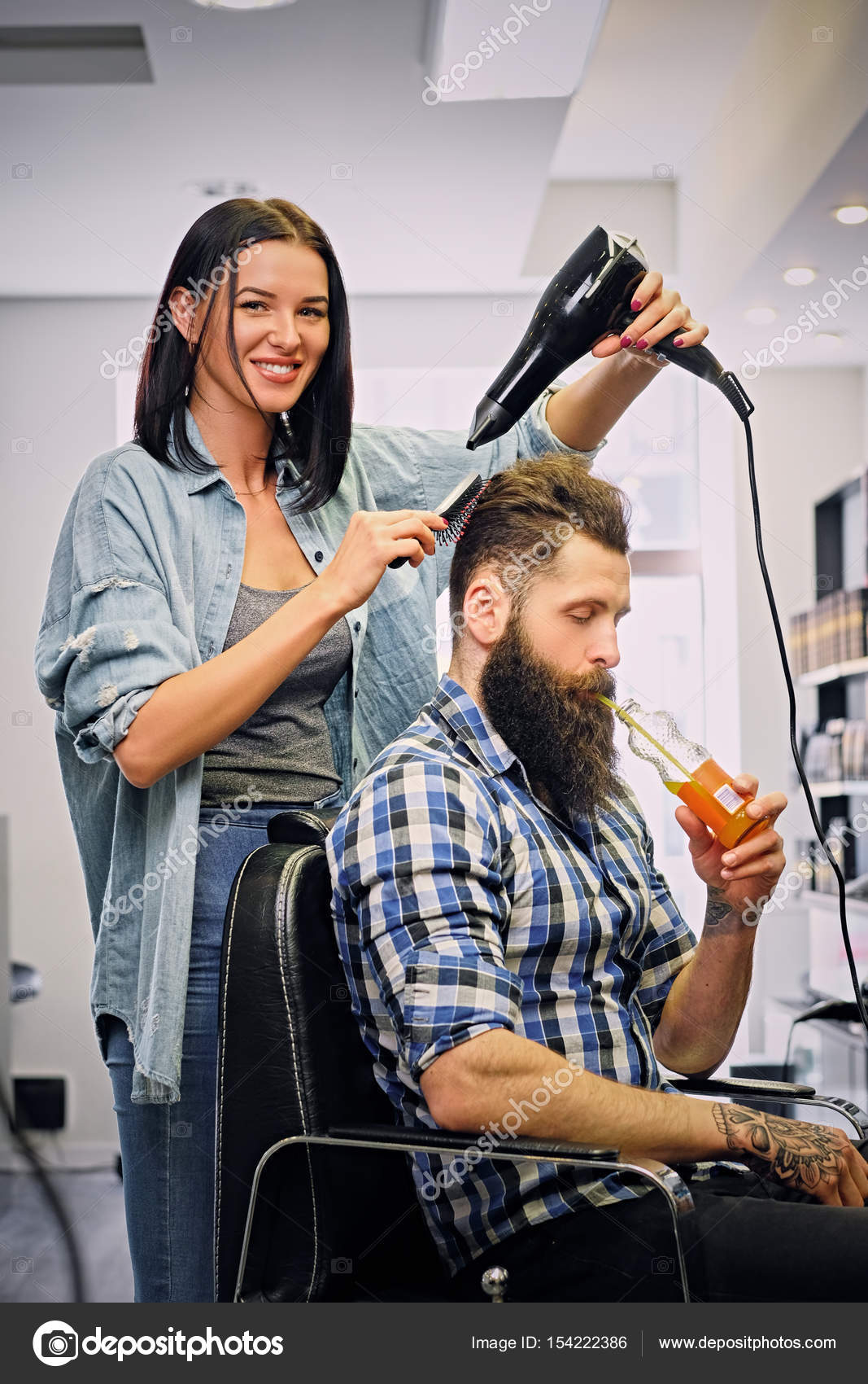 Hairdresser doing a hairstyle with hair dryer Stock Photo by ©fxquadro  154222386
