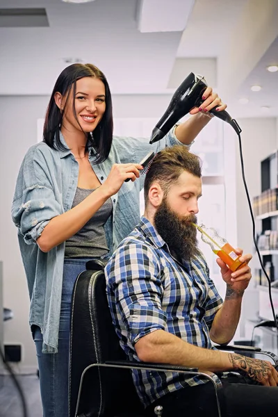Kuaför Saç kurutma makinesi ile bir saç modeli yapmak — Stok fotoğraf