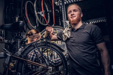 Bicycle mechanics in a workshop clipart
