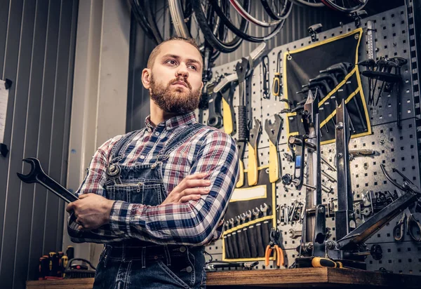 Tamirci anahtarı aracı sandalyesinden tutar. 