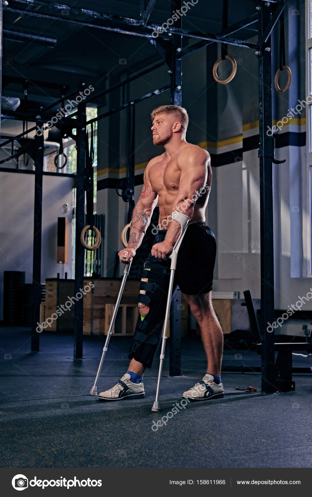 Shirtless bodybuilder on crutches Stock Photo by ©fxquadro 158611966