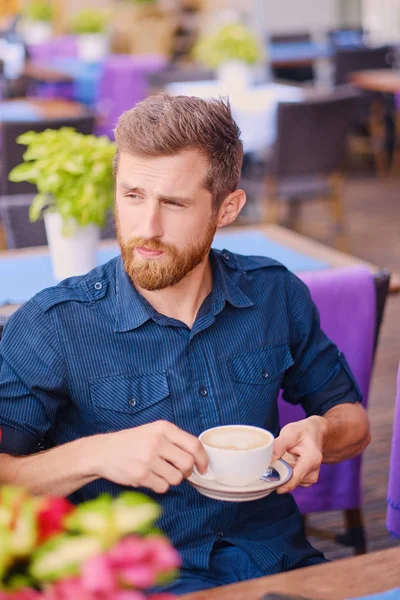 Man in a cafe on a street — Stock Photo, Image