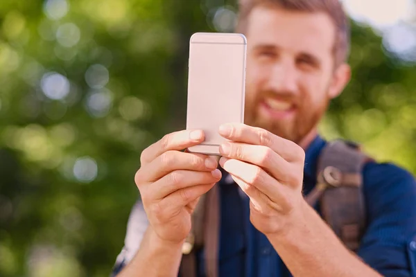 Man holds silver smart phone — Stock Photo, Image