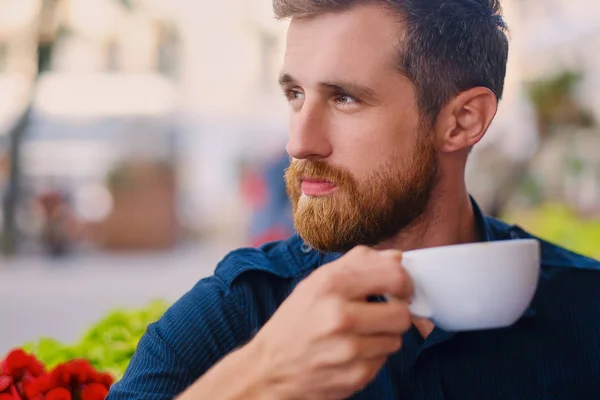 Man drinks coffee in a cafe