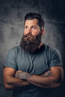 Bearded male with tattoos on arms clipart