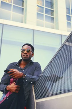 Siyah Amerikalı bir akıllı telefon kullanan erkek