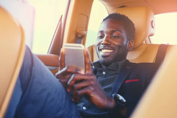 Black male using a smart phone — Stock Photo, Image
