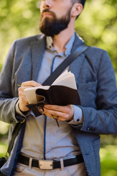 Man writing a message to a notepad — Stock Photo, Image