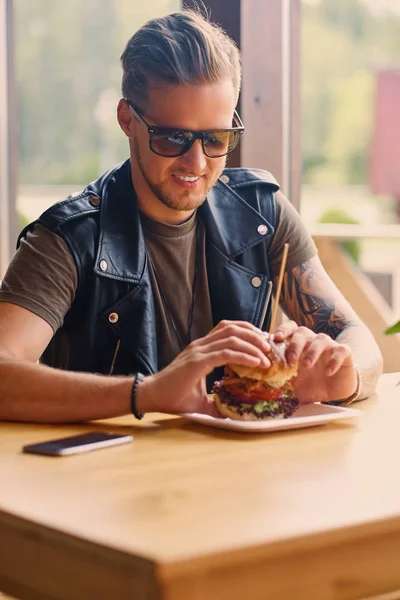 Hipster τρώγοντας ένα μπέργκερ για χορτοφάγους — Φωτογραφία Αρχείου