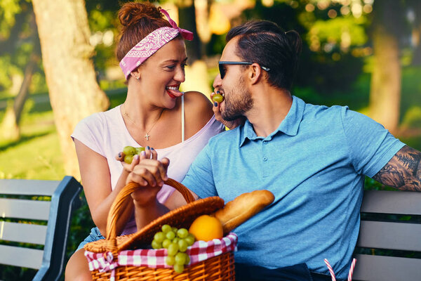 Bearded male and redhead female in a park