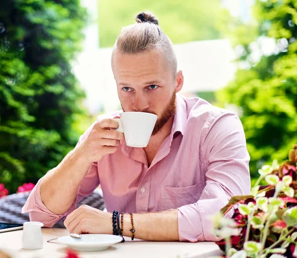 Man drinks coffee in cafe