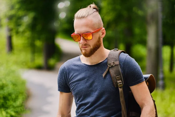 Portrait of redhead male in sunglasses.