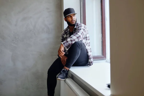 Hipster dressed in a fleece shirt and a cap — Stock Photo, Image