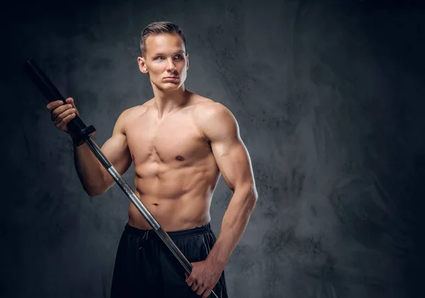 Muscular male holds barbell — Stock Photo, Image