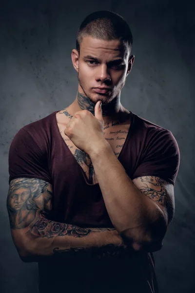Tattooed male with crossed arms