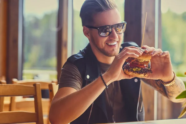 Hipster comer um hambúrguer vegan — Fotografia de Stock