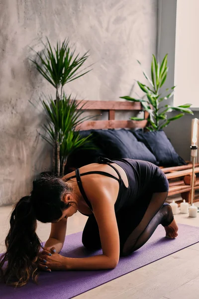 Female doing yoga on mat