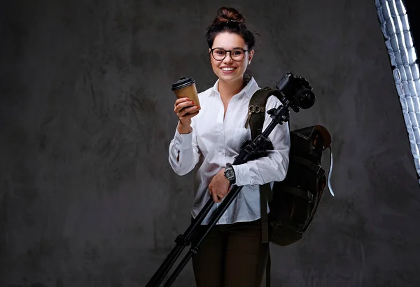 Traveler female holds photo camera