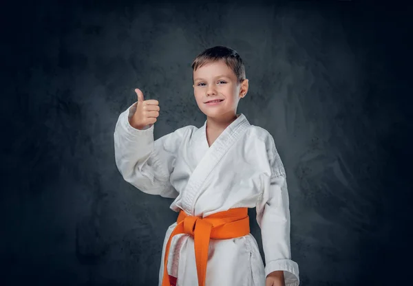 Boy dressed in a white karate kimono — Stock Photo, Image