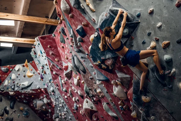 Professionella kvinnliga klättrare på bouldering vägg. — Stockfoto
