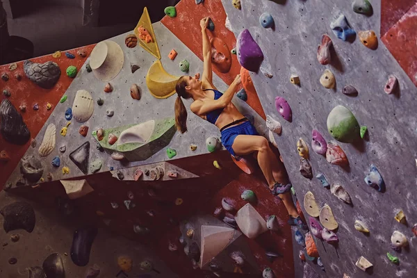 Professionella kvinnliga klättrare på bouldering vägg. — Stockfoto