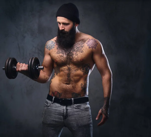 Shirtless male holds dumbbell — Stock Photo, Image