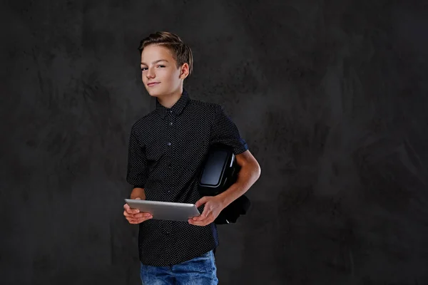 The positive teenager boy holds tablet PC. — Stock Photo, Image