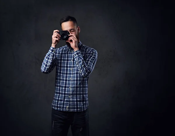 A man taking pictures with a compact camera.