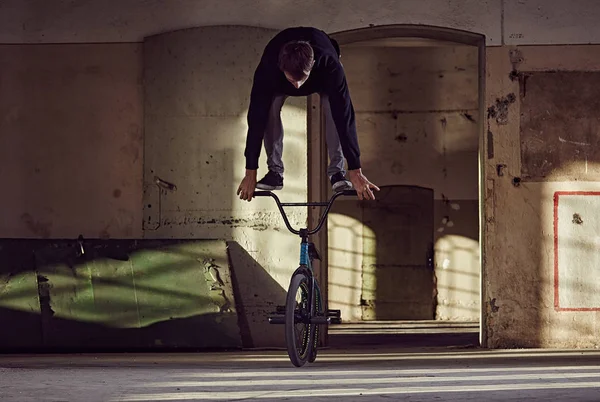 BMX rider doing stunts with a bicycle.