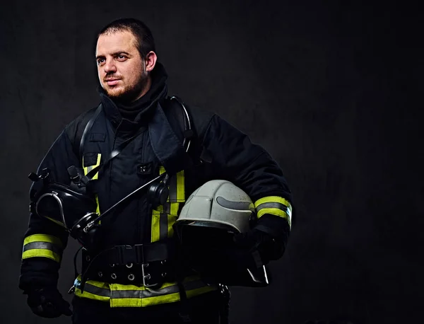 Firefighter holds safety helmet — Stock Photo, Image