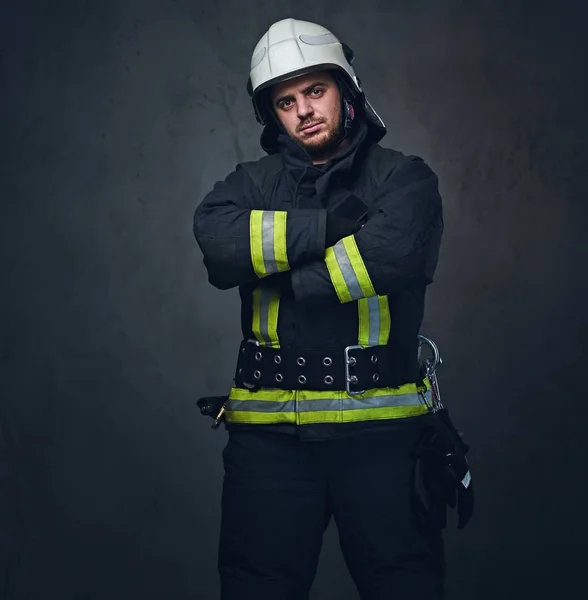 Studio portrait of firefighter dressed in uniform. — Stock Photo, Image