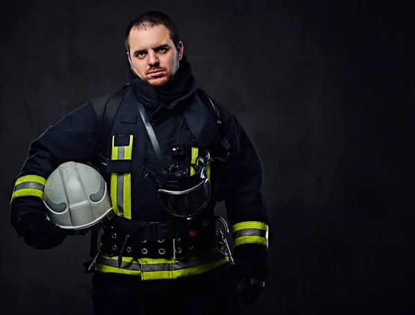 Firefighter holds safety helmet — Stock Photo, Image