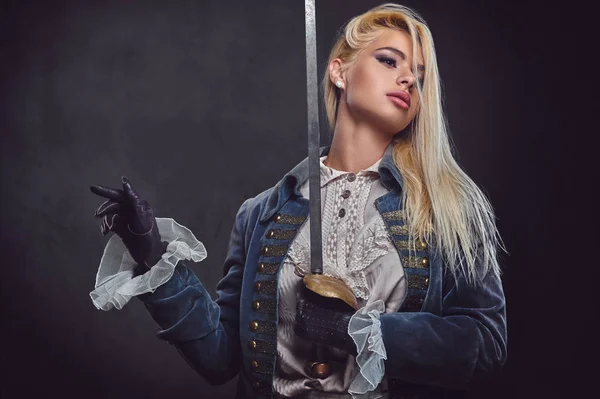 An attractive blonde female holds a silver sword. — Stock Photo, Image
