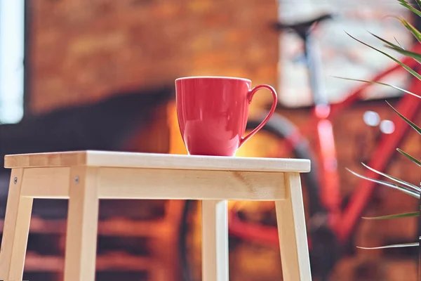 Röd kaffekopp på ett bord. — Stockfoto