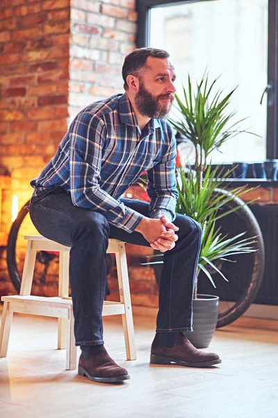 Мужчина с бородой, хипстер на деревянном стуле — стоковое фото