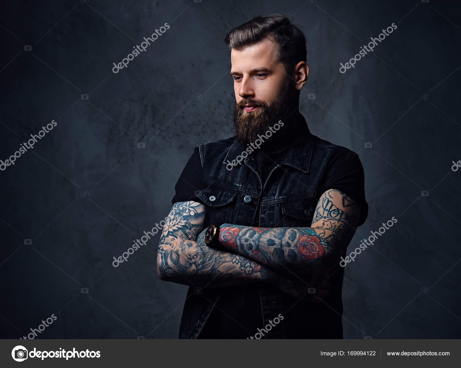 Bearded hipster male with tattoos on his arms Stock Photo by ©fxquadro  169994122