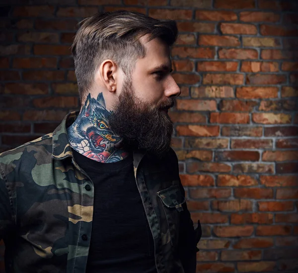 Tattooed bearded male in military jacket. — Stock Photo, Image