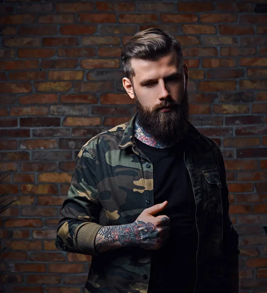 Tattooed bearded male in military jacket. — Stock Photo, Image