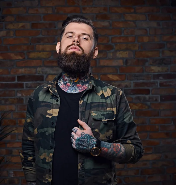 Tattooed bearded male in military jacket. — Stock Photo, Image