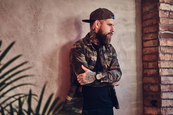 Tattooed male dressed in a military jacket — Stock Photo, Image